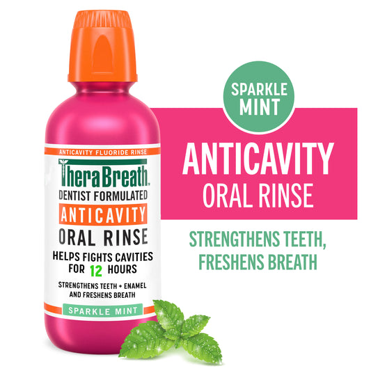 A pink bottle of TheraBreath Anticavity Oral Rinse Sparkle Mint flavor that "strengthens teeth," and "freshens breath"